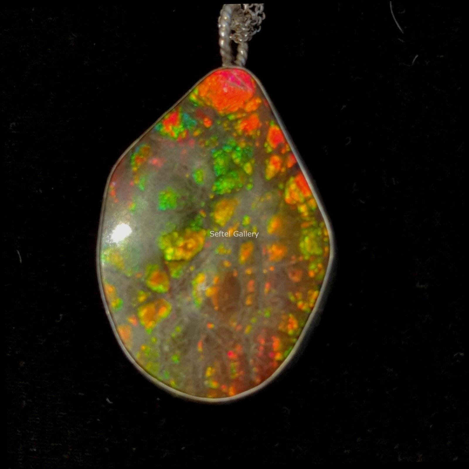 Double sided ‘Inner Fire’ Ammolite Specimen with Sterling Silver bezel and loop.